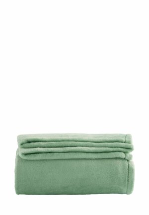 Pehme vihreä fleece-peitto siististi taitettuna valkoisella taustalla, näyttää sileää rakennetta ja siistejä reunoja.
