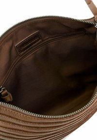 Brown leather handbag with ribbed texture, featuring a zip closure and interior pocket, lined with smooth brown fabric.