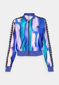 Giacca a zip Kappa di un blu e viola brillanti con strisce multicolori, nastro con logo nero sulle maniche, polsini e vita a coste.