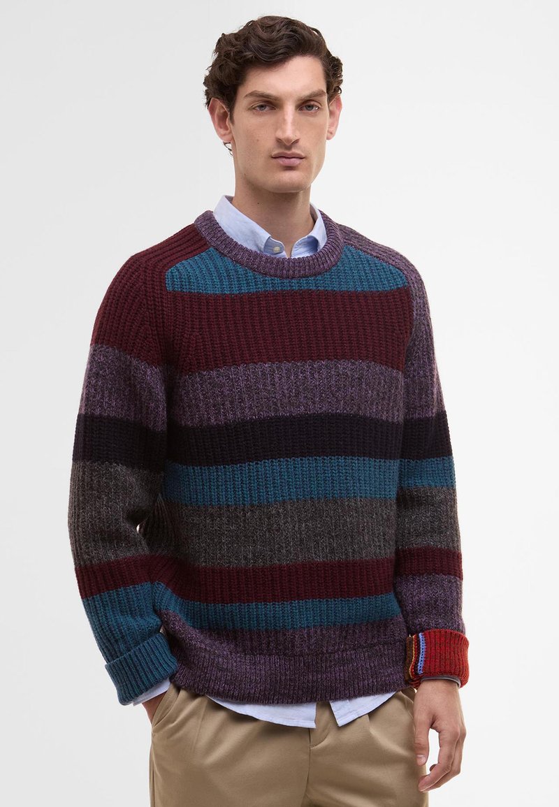 Knitted sweater featuring multicolored horizontal stripes in burgundy, teal, purple, and gray. Ribbed collar and cuffs, relaxed fit.