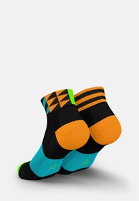 Multicolored socks featuring a geometric pattern in orange and blue, black body with green accents on the toes, heel, and top band.
