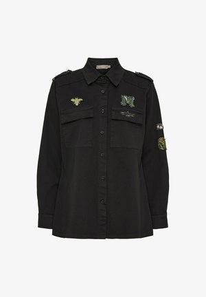 Sort skjorte med knapper har to brystlommer, broderet bi og bogstavet 'M' detaljer samt skulderepauleter. Blødt stof, almindelig pasform.