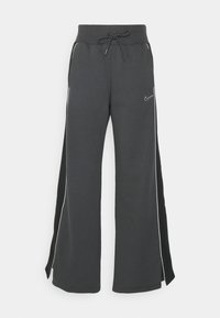 Nike wide-leg sweatpants in dark gray cotton blend. Elastic waistband with drawstring, side pockets, white piping, and logo accent.