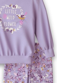 Lavender sweatshirt with floral design and "Little Wild Flower" text, paired with matching floral-patterned leggings. Soft, textured fabric.