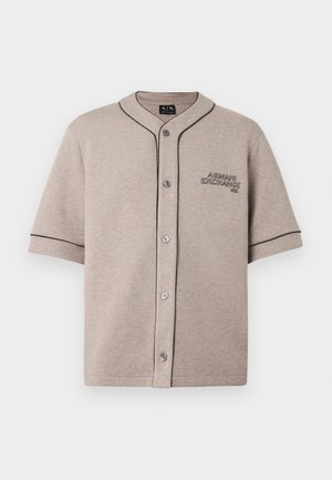 Cămașă scurtă cu mâneci scurte, de culoare bej deschis, dintr-un material moale, cu tiv negru contrastant și logo brodat pe pieptul stâng.