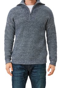 Stickad muddtröja i mörkblått med ett texturerat mönster, med en dragkedjekrage och ribbade ärmslut och nederkant.