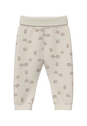 Pantalons de survêtement en coton beige avec un motif de hérisson répétitif, taille élastique et poignets. Texture douce avec une coupe décontractée.
