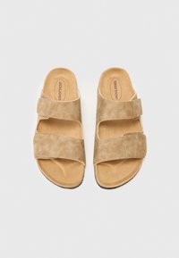Beige ruskindssandaler med to justerbare remme, åben tå-design og en polstret sål, der har en gummiydersål for godt greb.