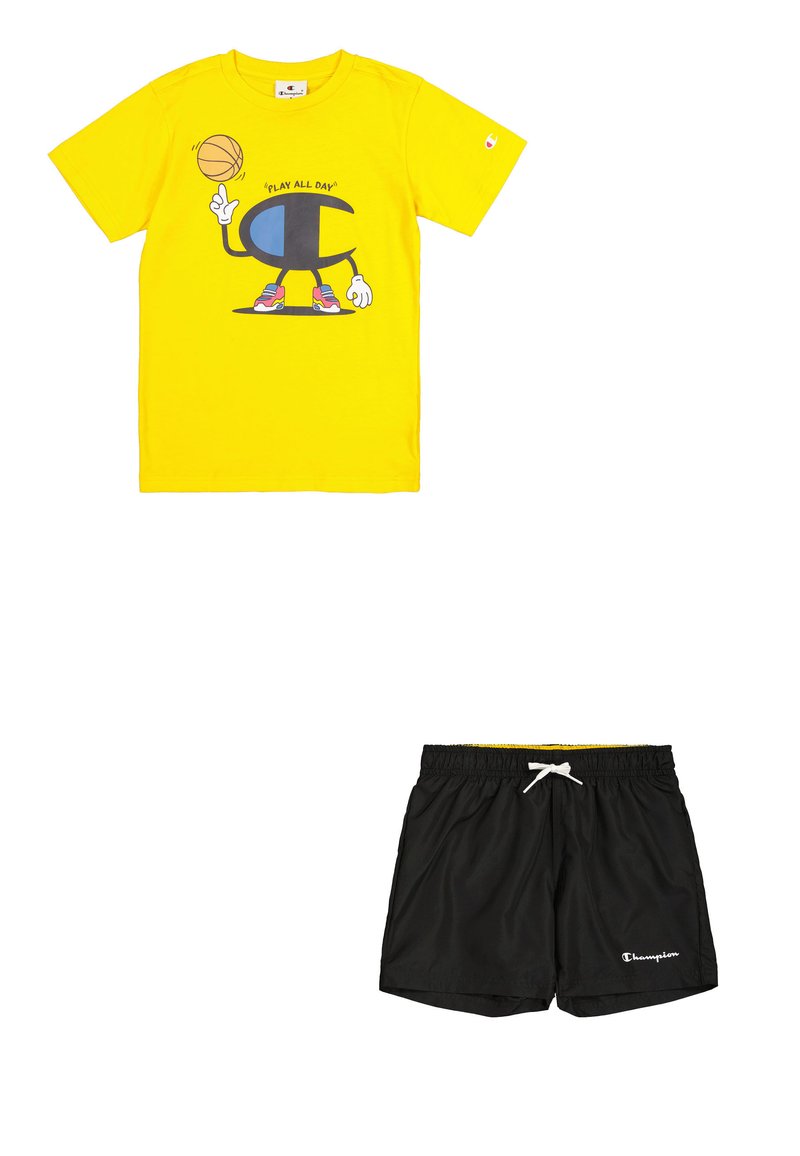 Camiseta de algodón amarilla con un gráfico de baloncesto y el texto "JUGAR TODO EL DÍA". Pantalones cortos ligeros negros con cinturilla elástica y logo de Champion.