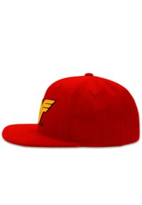 Red baseball cap made of fabric, featuring a prominent yellow wing logo on the front, flat brim, and six-panel design.