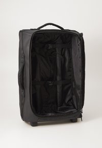 Black wheeled duffel bag with zippered closure, two handles, and adjustable interior straps. Textured outer fabric, spacious empty interior.