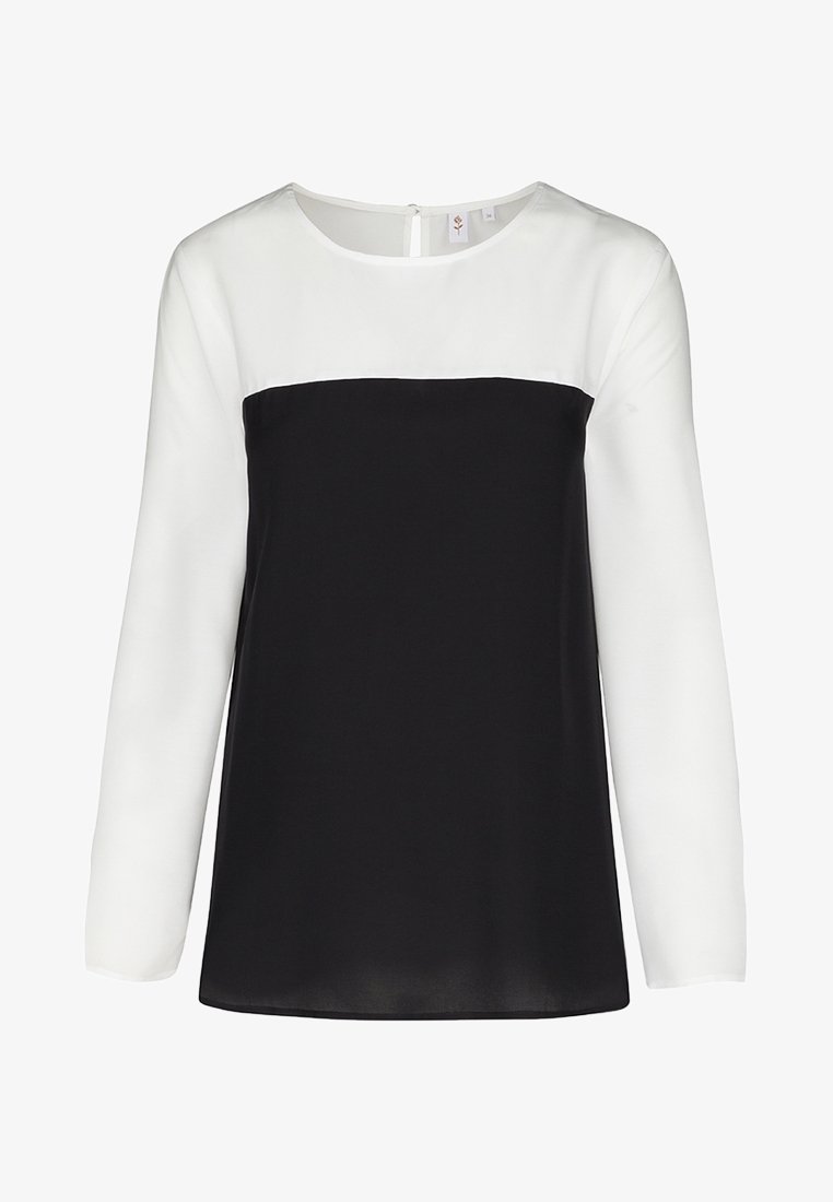 Blouse met lange mouwen met een zwart onderste gedeelte en een wit bovenste gedeelte. Heeft een ronde hals en een rits aan de achterkant. Gladde textuur over het hele oppervlak.