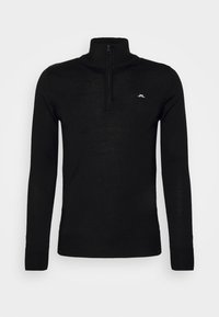 Black knit pullover with a quarter zip and high collar. Features ribbed cuffs and a small white logo on the chest. Smooth texture.
