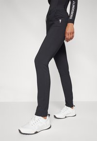 Kjus WOMEN WARM STRETCH TREGGINGS - Auduma bikses - black