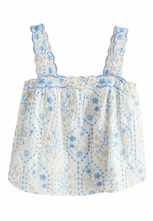 Fehér ujjatlan blúz kék és bézs virágos hímzéssel, hullámos szegélyekkel a pántokon és a nyakkivágásnál.