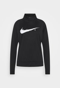 Mustapohjainen Nike-puolipitkä vetoketjulli paita, jossa on pitkät hihat, suurta valkoista swoosh-logoa ja kontrastiväristä tekstiä rinnassa. Sileä kangastunnus.