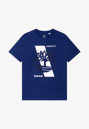 Camiseta de algodón azul marino con un diseño gráfico blanco que incluye un logo de árbol y la frase "Establecido en 1973", cuello redondo y mangas cortas.