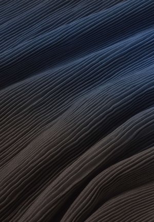 Tmavomodrá látka s úzkymi, rovnomerne rozmiestnenými vertikálnymi záhybmi vytvárajúcimi textúrovaný, vlnitý povrch.