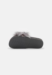 Grey slipper featuring a soft faux fur upper, a pink metallic accent, and a ridged black rubber sole for traction.