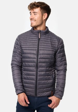 Gray quilted jacket with a stand-up collar, front zip closure, and ribbed detailing on shoulders and sleeves. Features a leather label accent.