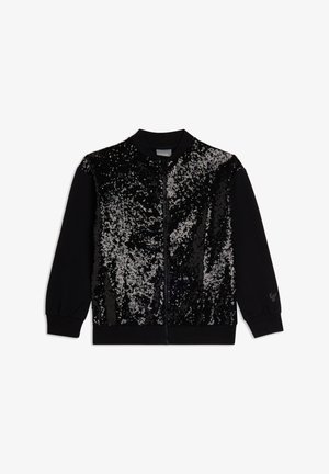 Chaqueta negra con cremallera que presenta un panel frontal con lentejuelas y efecto degradado. Puños y cuello acanalados, con un logo en la manga izquierda.