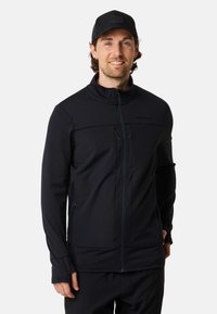 Zwart zip-up jacket met een hoge kraag, textuurpanelen, twee voorzakken met rits en een aansluitende pasvorm. Draagt in combinatie met bijpassende donkere broek.