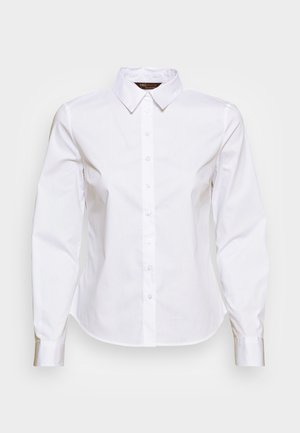 Camicia bianca a maniche lunghe con colletto, chiusura frontale a bottoni e design aderente. Il materiale sembra liscio e leggero.