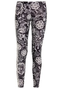 Mustat leggingsit, joissa on valkoinen kukkakuvioinen pitsipattee, jossa on monimutkaisia yksityiskohtia, valkoiset sivuraidat korostavat tyyliä. Pehmeä, joustava kangas.