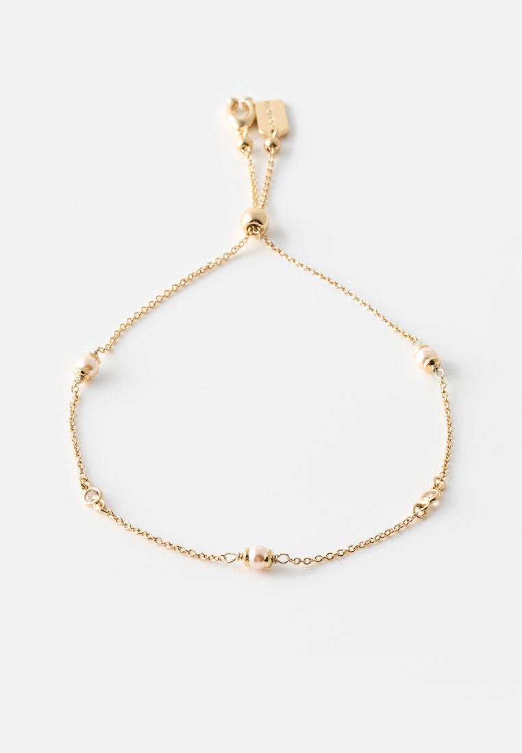 Bracelet en or avec une chaîne délicate ornée de quatre accents sphériques. Fermeture à mousqueton avec un design de longueur ajustable.