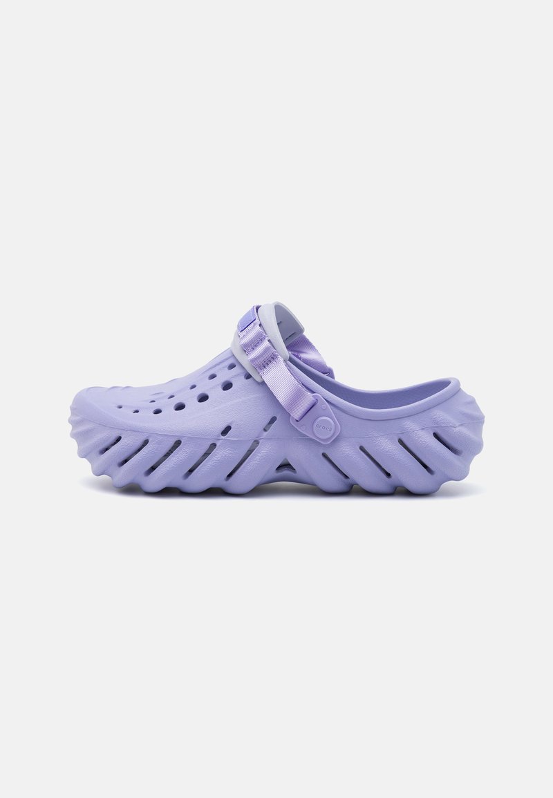 Light purple clog with open holes for ventilation, a strap for secure fit, ridged sole for traction, and textured surface.