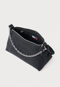 Fekete farmer anyagú táska cipzárral, ezüst lánc pánttal és dombornyomott logó részlettel az elején. Masszív kialakítás, puha tapintású felület.