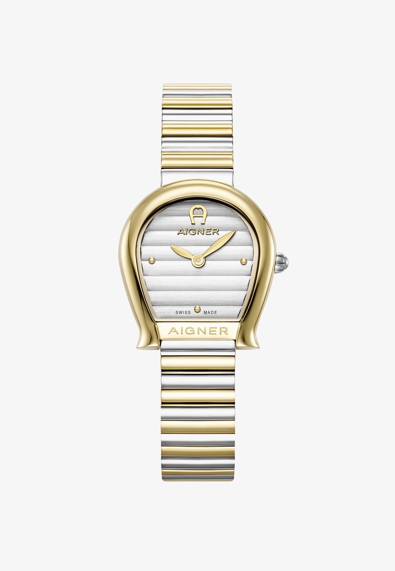 Montre ton or et argent avec un boîtier ovale unique, un cadran argent texturé et un bracelet métallique rayé. Présente la marque Aigner et un mouvement suisse.