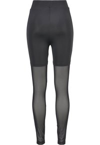 Svarta leggings med en slät, ogenomskinlig övre del och genomskinliga mesh-nederdelar; elastisk midja för komfort och passform.