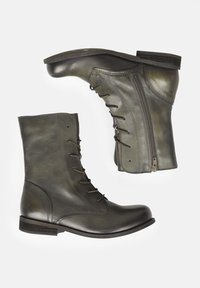 Zelené kožené kotníkové boty s kulatou špičkou, šněrováním vpředu a bočním zipem. mají hladký povrch a nízký vrstvený podpatek.