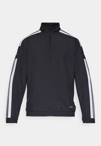 Black track jacket featuring a high collar, full zip, and white stripes along the shoulders. Elastic cuffs and waistband complete the design.