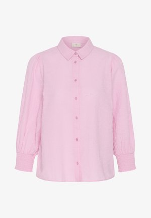 Blouse rose clair à manches longues avec devant boutonné, manches bouffantes, poignets froncés et col pointu, en tissu texturé.