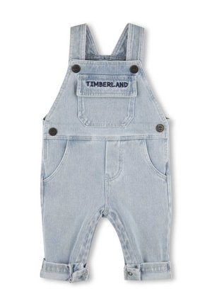 Light blue denim baby overalls with adjustable straps, front pocket labeled "Timberland," side buttons, and rolled-up pant legs.