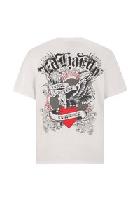 White short-sleeve t-shirt featuring a large graphic on the back with a heart, wings, and the text “Death Before Dishonor” in black and red.