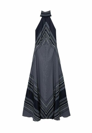 Sleeveless halter neck maxi dress with black and white geometric and striped patterns forming chevron and dotted designs.
