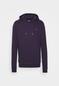 Felpa viola realizzata in tessuto morbido, con tasca a marsupio, cordini e un piccolo logo dorato sul petto. Maniche lunghe con polsini a costine.