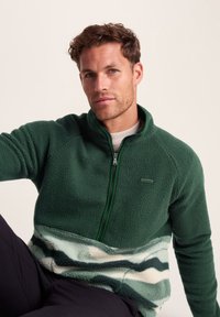 Green fleece pullover with a half-zip design, textured material, and a gradient pattern featuring shades of mint and white at the hem.