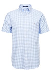 Camicetta azzurra a maniche corte con bottoni e motivo a quadri. Presenta una tasca sul lato sinistro del petto e un colletto tradizionale. Tessuto in misto cotone.