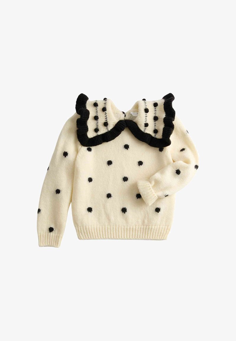 Crèmekleurige gebreide trui met zwarte stippen en een grote geplooide kraag afgezet met zwart.