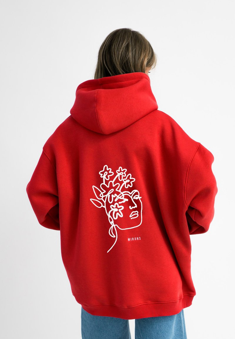Rode hoodie met witte lijntekening van een gezicht met bloemen. Gemaakt van zachte stof, met een losse pasvorm en geribde onderrand.