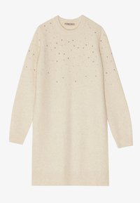 Cream-colored knitted sweater dress with long sleeves, round neckline, and scattered metallic embellishments on the upper section.