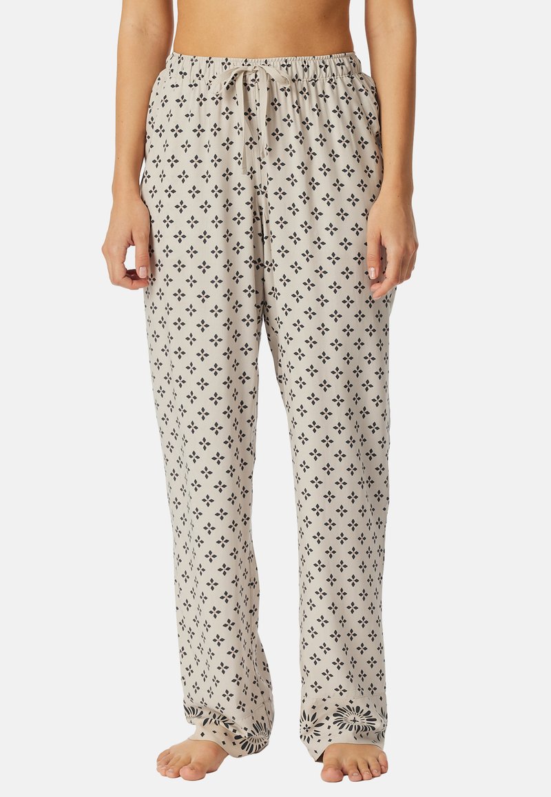 Lichtbeige loungebroeken met zwarte bloemen- en diamantpatronen. Voorzien van een elastische tailleband met drawstring voor een aanpasbare pasvorm.