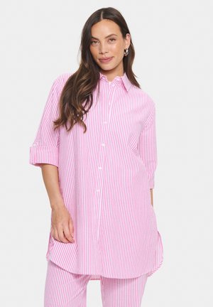 Lightweight, pink and white striped shirt with long sleeves, button-down front, and curved hemline. Soft fabric with a relaxed fit.