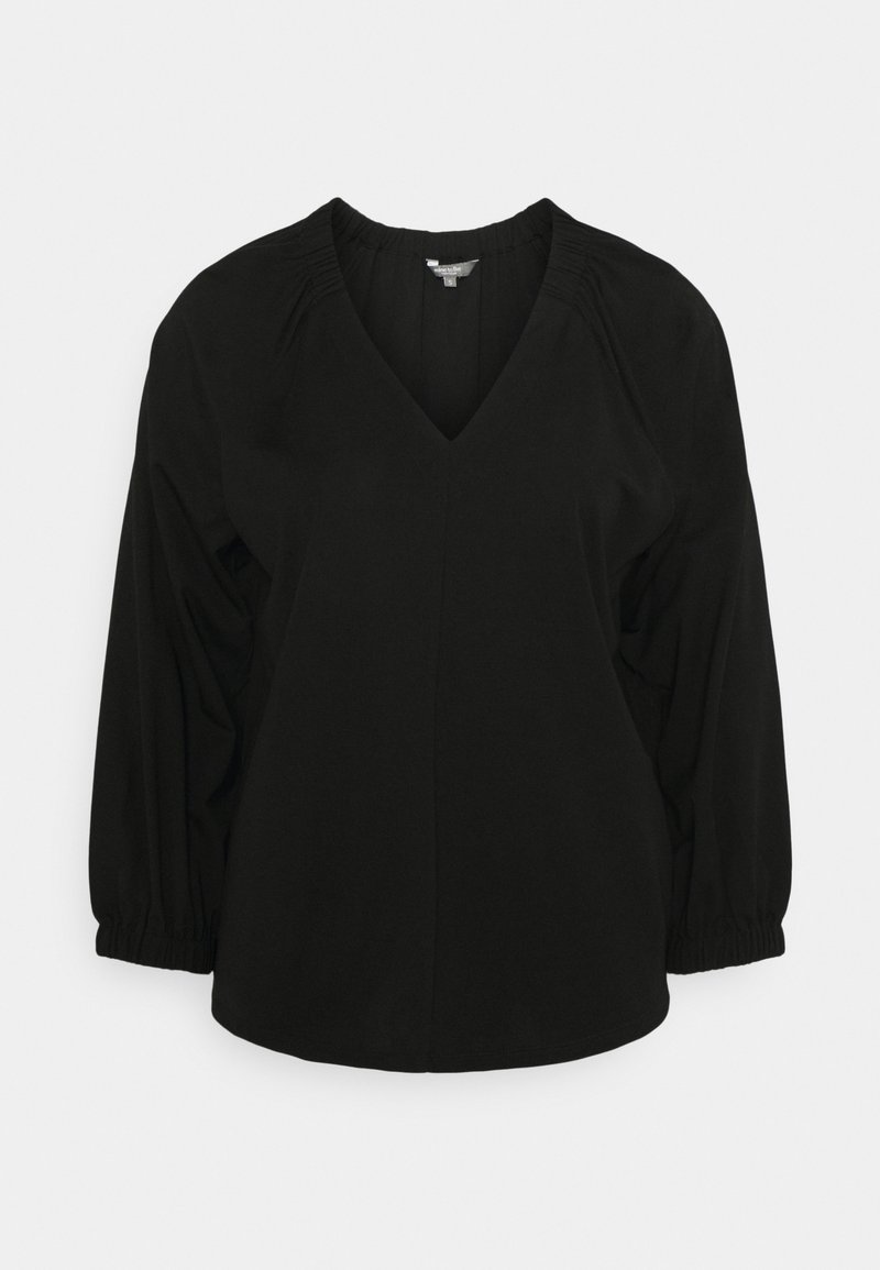 Blouse noire avec col en V, manches longues bouffantes et détails froncés aux épaules. Réalisée en tissu léger, elle présente une coupe décontractée.