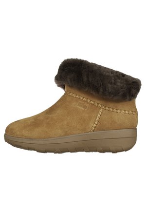 Brown suede ankle boot with a curly dark fur cuff, stitched detailing, and a thick rubber sole with textured tread for grip.