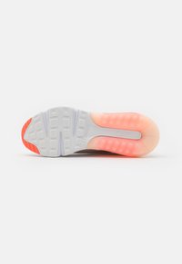 White shoe sole with textured grip pattern, featuring a translucent orange and pink gradient at the heel and a red accent on the toe.